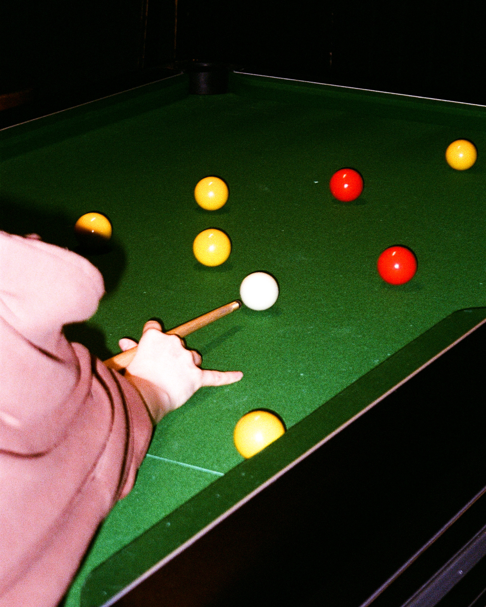 Person playing pool at the famous three kings